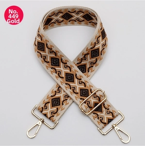 Close-up of geometric woven strap No. 449 with golden metal hooks for shoulder bags