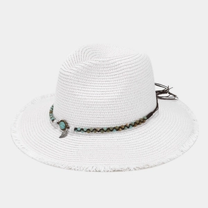 Detail of white straw fedora with bohemian beaded band, turquoise beads and leaf pendant