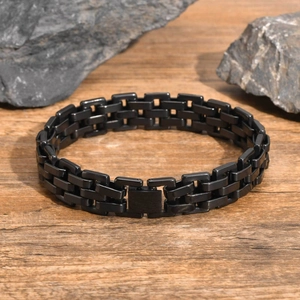 Detail shot of black stainless steel double-row link bracelet with folding clasp and texture