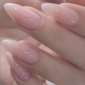 Glossy pink gradient almond press-on nails with a long pointed professional finish
