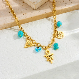 Gold stainless steel necklace with Egyptian pendants and blue turquoise on beige stone