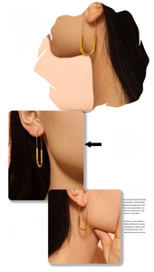 Detailed view of U-shaped gold earrings in a paperclip style made of polished 18k plated steel