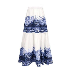 Detailed view of high-waisted white maxi skirt with ornate blue floral patterns