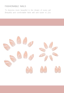 Flat lay of almond press-on nails featuring elegant white swirl patterns on nude base