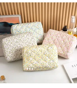 Detailed set of four floral quilted cotton toiletry bags in pastel assorted colors