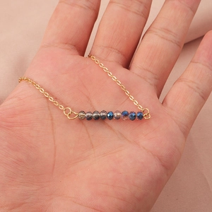 Gold stainless steel necklace featuring a gradient of 4mm faceted glass beads