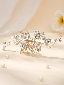 Detail of bridal hair comb with handmade rhinestones and pearls on golden wire