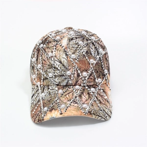 Detail of camouflage baseball cap with white faux pearls and silver metal studs