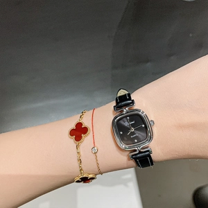 Elegant silver square quartz watch with black leather strap and gold clover bracelets