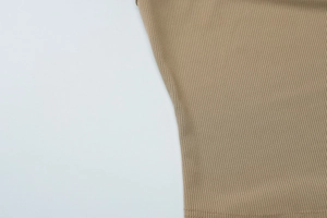Close-up of brown ribbed knit fabric texture on a slim fit cropped tank top