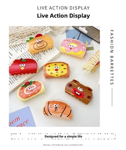 Close-up of colorful acrylic hair clips with toast, strawberry and donut designs