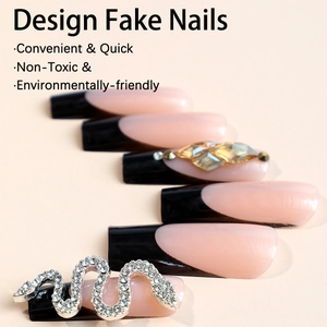 Long French press-on nails with black tips and 3D rhinestone snake and gold gems