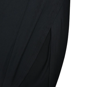 Detail shot of black slim fit jumpsuit showing side slit and fabric texture up close
