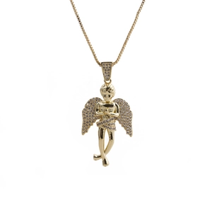 Detailed macro view of a golden angel pendant with sparkling crystals on a box chain
