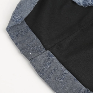 Close-up of distressed blue denim knit beanie cuff with durable black lining and clean stitching