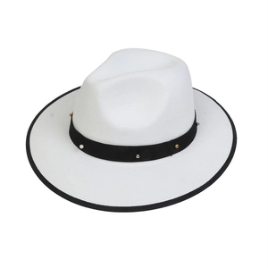 Detailed macro view of white fedora hat with black studded band and pearl accent decoration