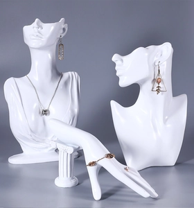 Macro detail of resin necklace busts and hand model displaying fine jewelry for windows