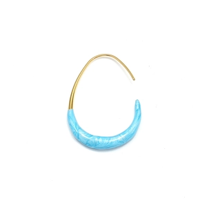 Macro detail of U-shaped gold earrings with sky blue marble enamel texture inlay
