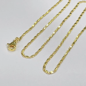 Close-up of 18k gold plated flat tile chain necklace with lobster clasp on white background
