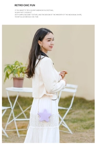 Star-shaped lilac PVC jelly bag with gold chain strap shown on outdoor grass