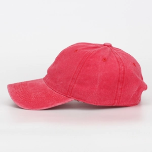 Detailed side view of a vintage washed pink cotton baseball cap with breathable eyelets
