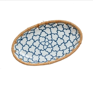 Oval ceramic plate with blue floral patterns and natural woven rattan edges for snacks