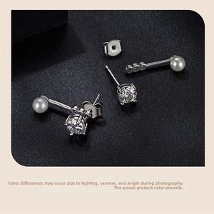 Macro detail of S925 sterling silver stud earrings with moissanite and round white pearl