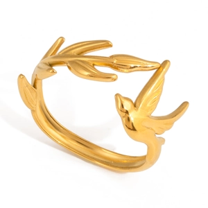 Macro detail of 18K gold stainless steel olive leaf bird ring with white zircon stones