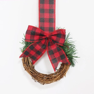 Christmas cabinet wreath with red and black buffalo plaid bow on a natural vine ring