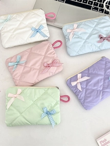 Quilted bow makeup pouch in pastel colors with elegant ribbon and diamond stitch design