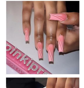 Macro detail of pink glitter long coffin press-on nails with matte diagonal stripes