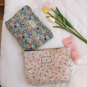 Floral cotton makeup bags with zipper and Time To Party label on white linen