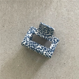 Detail of blue terrazzo pattern on large square hair claw clip with spring mechanism