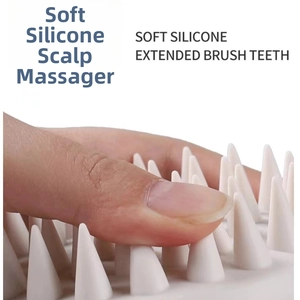Macro shot of flexible silicone scalp massager teeth showing soft material flexibility