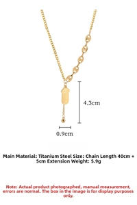 Macro detail of gold titanium steel necklace with engraved longevity pendant charm
