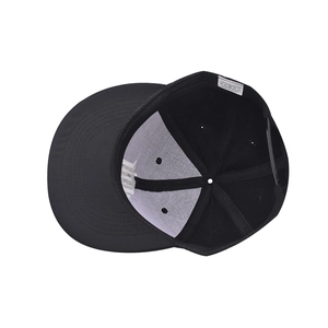 Detail view of cotton baseball cap interior showing 100% polyester lining and wash label