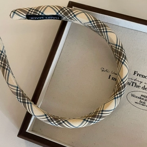 Detailed view of handmade plaid headband with vintage brown check fabric and inner label