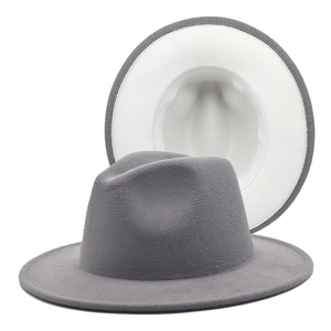 Detailed view of gray fedora hat with white interior lining and wide brim design