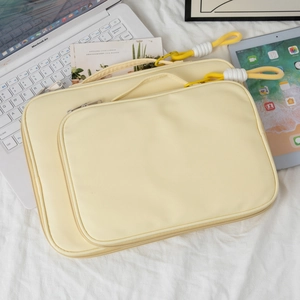 Detailed set of cream yellow nylon laptop and tablet sleeves with yellow zipper pulls