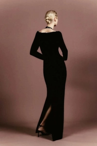 Close-up of elegant black backless evening gown with sparkling silver rhinestone trim