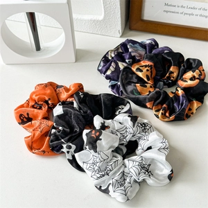 Halloween scrunchies set featuring pumpkin and ghost patterns on satin fabric for women