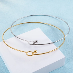 Detail of minimalist gold and silver stainless steel choker necklaces on display