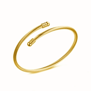 Detailed macro view of the gold-plated cable wire cuff bracelet with spherical finials