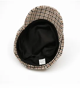 Close-up of the black inner lining and fabric composition label inside the plaid cap