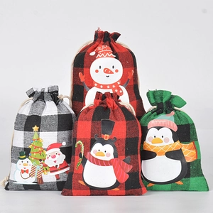 Christmas buffalo plaid drawstring gift bags featuring Santa, snowman and penguin patterns