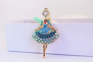 Macro view of a dancing girl metal pendant with blue and colorful rhinestones