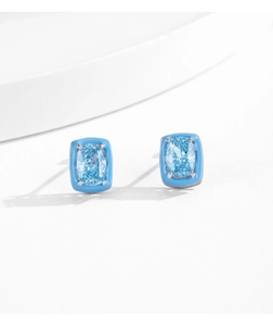 Detailed view of light blue square crystal stud earrings on minimalist studio props