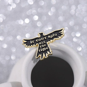 Crow enamel bird brooch with It Can't Rain All The Time quote in gold and black