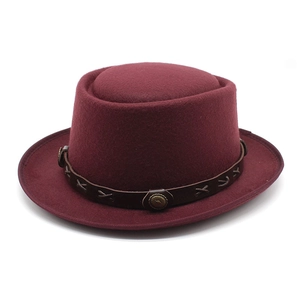 Close-up of burgundy wool boater hat with braided leather band and metal stud details
