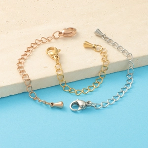 Macro detail of stainless steel extender chains with lobster clasps and teardrop charms